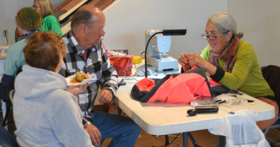 Robert Mueri/staff photos
Susan Spurlin uses her sewing skills to mend a coat at Green Okanogan's Repair Café held last Saturday at the Community Cultural Center at Tonasket.