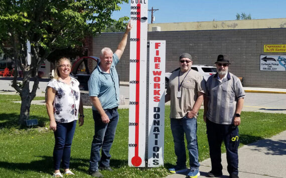 Shelly Roberts, Rocky DeVon, Mayor Ed Naillon and Paul Bouchard with the Oroville Washington Chamber of Chamber pose with the community fundraising meter which shows that $7000 has been raised so far for the Fourth of July Community Fireworks Display at Deep Bay Park. The meter was constructed by Paul Bouchard Woodworking. <em>Submitted photo </em>