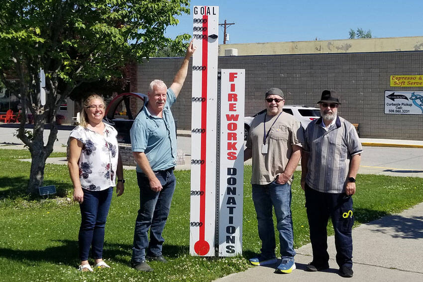 Shelly Roberts, Rocky DeVon, Mayor Ed Naillon and Paul Bouchard with the Oroville Washington Chamber of Chamber pose with the community fundraising meter which shows that $7000 has been raised so far for the Fourth of July Community Fireworks Display at Deep Bay Park. The meter was constructed by Paul Bouchard Woodworking. <em>Submitted photo </em>