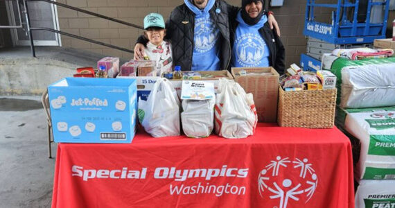 The Okanogan County Sasquatch organized a food drive to support local food banks. They were hosted by Lee Franks and Grants Market from 9 a.m. to 2 p.m. last Saturday, Nov. 2. Pictured with the generous donations of the Tonasket community are (l-r) Charlie Tonasket, Jason Utecht and Enrique Pio.  Submitted photo