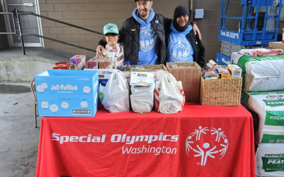 The Okanogan County Sasquatch organized a food drive to support local food banks. They were hosted by Lee Franks and Grants Market from 9 a.m. to 2 p.m. last Saturday, Nov. 2. Pictured with the generous donations of the Tonasket community are (l-r) Charlie Tonasket, Jason Utecht and Enrique Pio.  Submitted photo