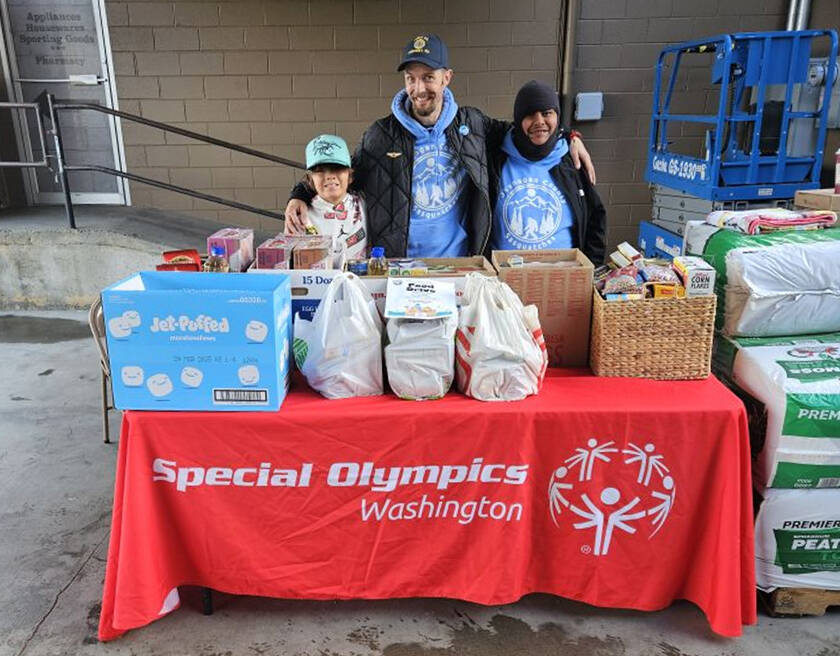 The Okanogan County Sasquatch organized a food drive to support local food banks. They were hosted by Lee Franks and Grants Market from 9 a.m. to 2 p.m. last Saturday, Nov. 2. Pictured with the generous donations of the Tonasket community are (l-r) Charlie Tonasket, Jason Utecht and Enrique Pio.  Submitted photo