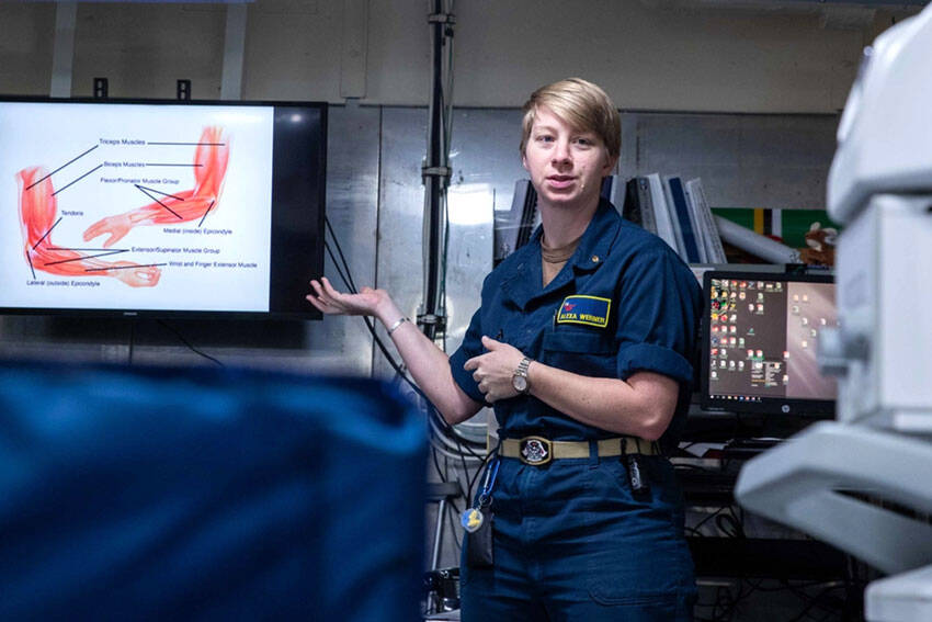 Lt. Alexa Werner, from Oroville, Washington, the ship’s physical therapist aboard Nimitz-class aircraft carrier USS George Washington (CVN 73), displays a muscle diagram during a sick call evaluation training in main medical while underway in the Philippine Sea, Nov. 20, 2024. George Washington is 7th Fleet’s premier forward-deployed aircraft carrier, a long-standing symbol of the United States’ commitment to maintaining a free and open Indo-Pacific region, while operating alongside Allies and partners across the U.S. Navy’s largest numbered fleet. (U.S. Navy photo by Mass Communication Specialist 3rd Class Johnathan M. Meighan)