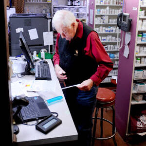 Dick Larson fills a prescription at Oroville Pharmacy. The business will close at the end of the year and Larson will retire. The store will open to its new owner sometime in 2025. <em>Gary De Von/staff photo</em>