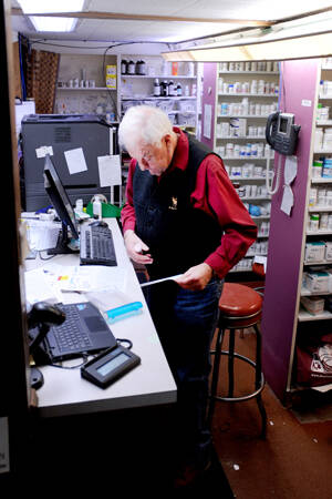 Dick Larson fills a prescription at Oroville Pharmacy. The business will close at the end of the year and Larson will retire. The store will open to its new owner sometime in 2025. <em>Gary De Von/staff photo</em>