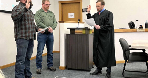 Nick Timm was sworn into the Okanogan County Board of Commissioners at their Monday, Dec. 31 meeting. Timm, left, will serve a four-year term as the District 1 Commissioner. Also taking the oath to serve another term was Andy Hover, who was re-elected to the District 2 position. Submitted photo