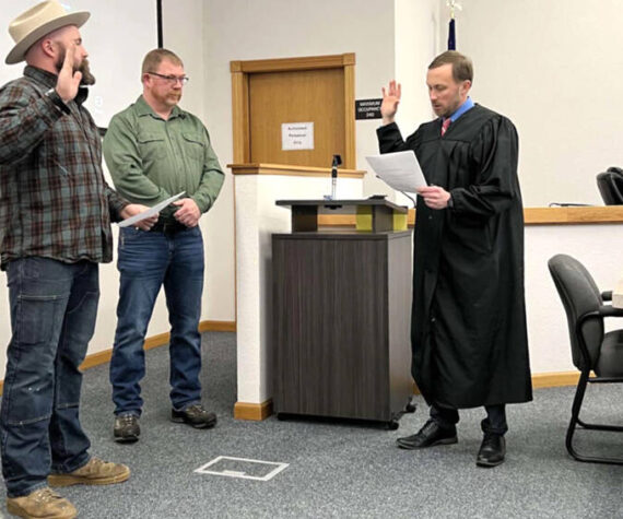 Nick Timm was sworn into the Okanogan County Board of Commissioners at their Monday, Dec. 31 meeting. Timm, left, will serve a four-year term as the District 1 Commissioner. Also taking the oath to serve another term was Andy Hover, who was re-elected to the District 2 position. Submitted photo