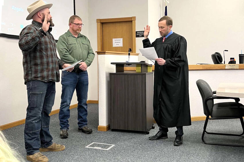 Nick Timm was sworn into the Okanogan County Board of Commissioners at their Monday, Dec. 31 meeting. Timm, left, will serve a four-year term as the District 1 Commissioner. Also taking the oath to serve another term was Andy Hover, who was re-elected to the District 2 position. Submitted photo