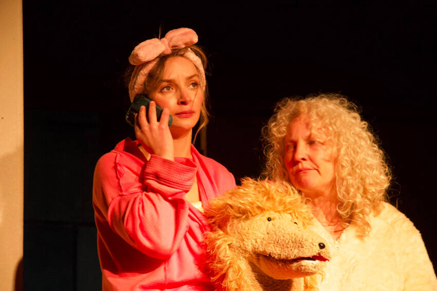 Danika Smith in the lead role as Diedra in “The Pack,” a new theater production showing at the Tonasket Community Cultural Center. She is seen here with Julie Alley, who plays the new poodle puppy Maxi. Rob Thompson/submitted photos